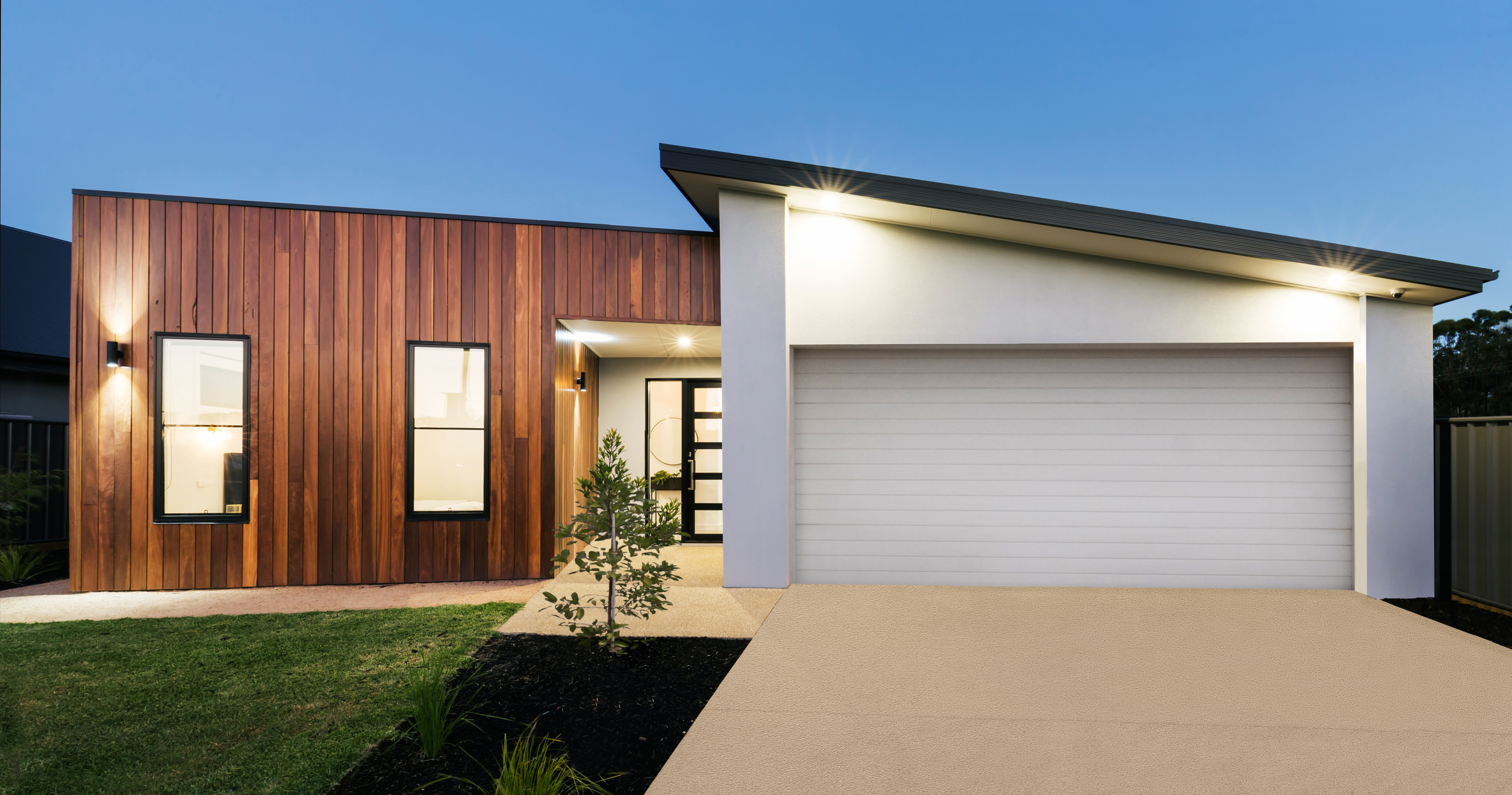 A modern brick house in hilly environment captured at dusk.